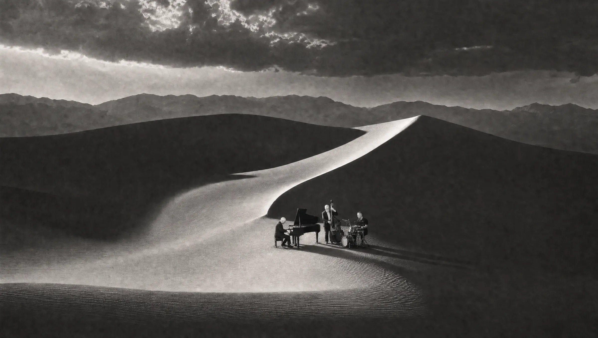 The Kristian Braathen Trio performing on a sand dune under a stormy sky